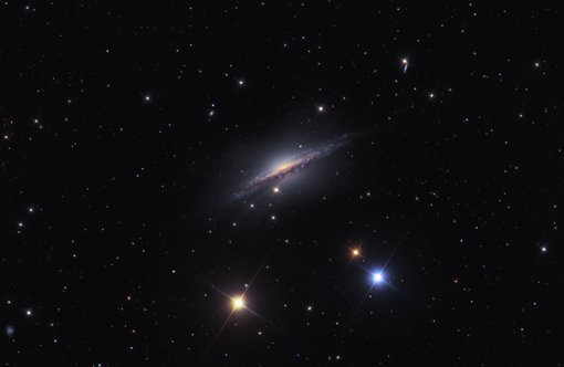 Abbildung 4: Bei genauerem Hinsehen erkennt man rund um diese Spiralgalaxie, NGC 1055 im Sternbild Walfisch, eine schwach schimmernde, eckige Umhüllung, die aus Sternen besteht – die Überreste einer kleineren Satellitengalaxie, die NGC 1055 sich einverleibt hat. NGC 1055 ist rund 60 Millionen Lichtjahre von der Erde entfernt. Mit dieser Durchmusterung ist es erstmals gelungen, Spiralgalaxien, die sich kleinere Satellitengalaxien einverleiben, jenseits unserer »lokalen Gruppe« von Galaxien nachzuweisen.