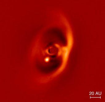 Near infrared image of the PDS70 disk obtained with the SPHERE instrument. The young exoplanet PDS 70 b is clearly detected as a bright signal at the inner rim of the gap (dark region). The emission coming from central star was masked out. The bar to the lower right indicates the linear scale of the image at a distance of 370 light years. Near infrared image of the PDS70 disk obtained with the SPHERE instrument. The young exoplanet PDS 70 b is clearly detected as a bright signal at the inner rim of the gap (dark region). The emission coming from central star was masked out. The bar to the lower right indicates the linear scale of the image at a distance of 370 light years.