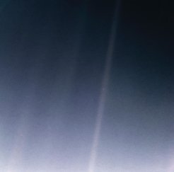 The "pale blue dot" image, Earth as photographed by the Voyager spacecraft in 1990, highlights the unique astronomical perspective on Earth as a comparatively small habitable planet in the hostile environment of space. Earth is visible as a tiny dot within one of the stripes. The stripes are caused by stray sunlight entering the camera.