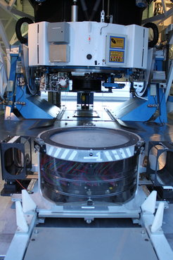 The final plate of the SDSS plate program sits at the base of the Sloan Telescope at the Apache Point Observatory in New Mexico, USA. The colored fibers visible below the plate have been plugged into their holes and will carry the light to the waiting instruments.