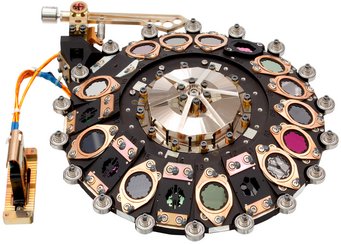 The filter wheel that allows MIRI to take images in different wavelength regions. MPIA was responsible for all planning, designing, building and testing the filter wheel’s mechanical and electrical components. The 18 optical elements include filters to narrow the wavelength range, coronagraphs to cover up bright objects, and a prism. The filter wheel that allows MIRI to take images in different wavelength regions. MPIA was responsible for all planning, designing, building and testing the filter wheel’s mechanical and electrical components. The 18 optical elements include filters to narrow the wavelength range, coronagraphs to cover up bright objects, and a prism.